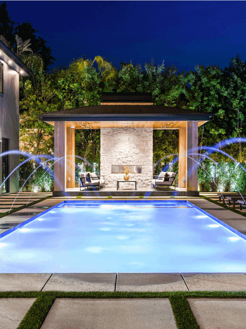 Luxury pool with illuminated water features.