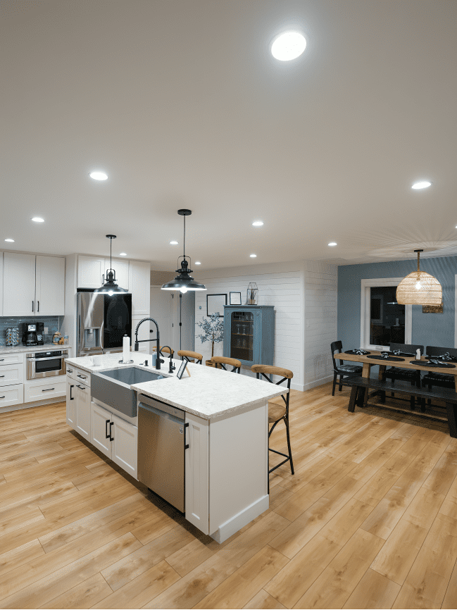 Modern kitchen with island and dining area.
