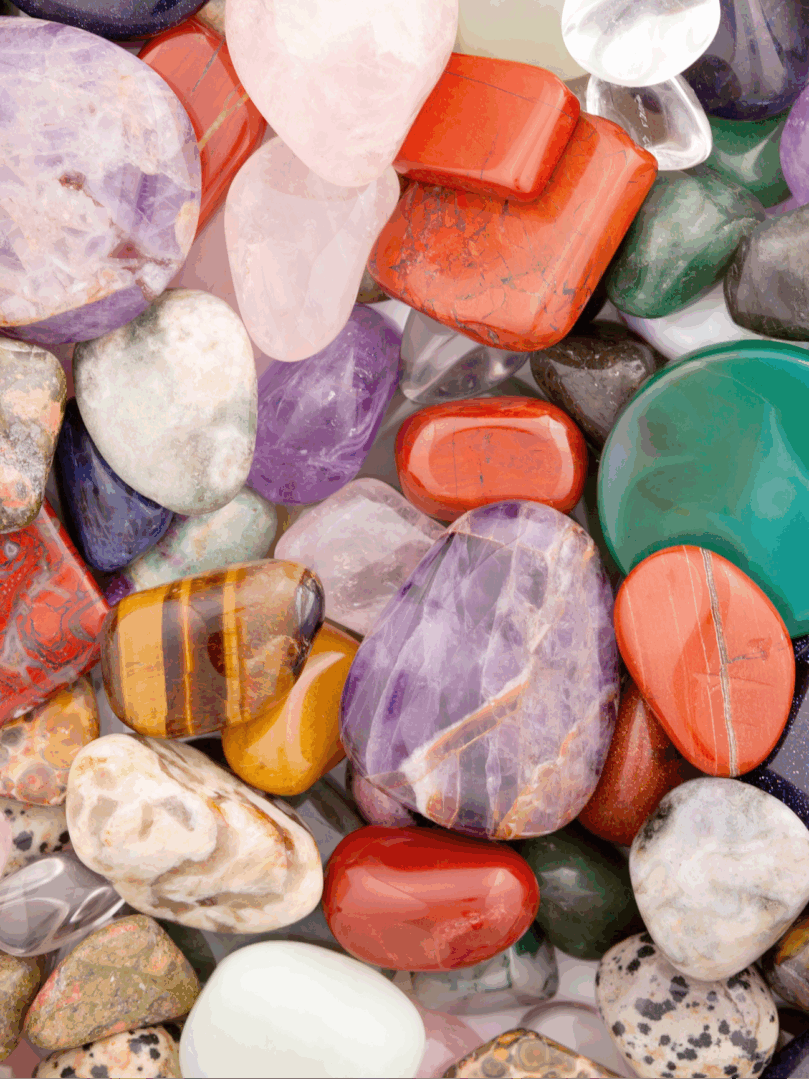 Colorful polished gemstones in various shapes.