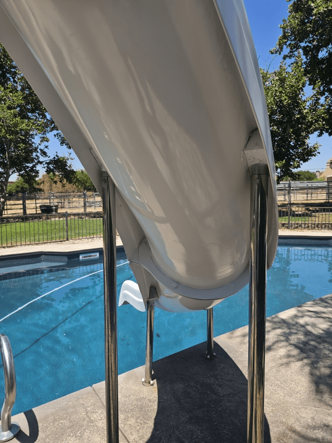 Pool slide with ladder and water.