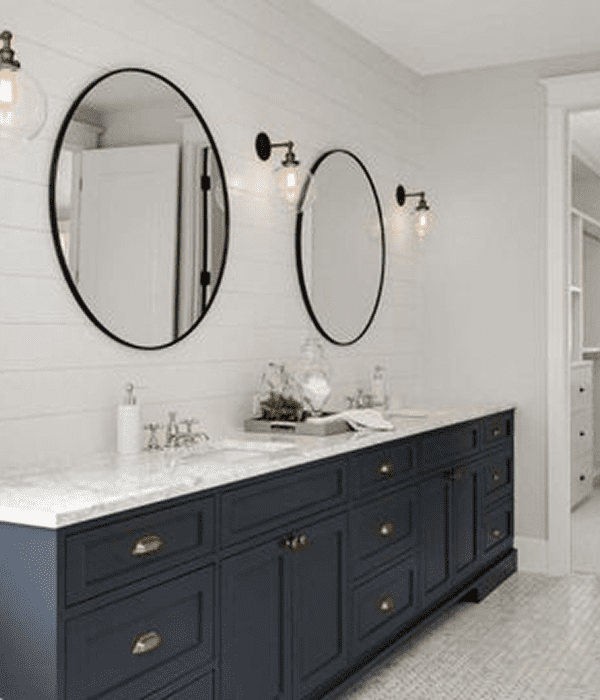 Modern bathroom with double vanity and mirrors.