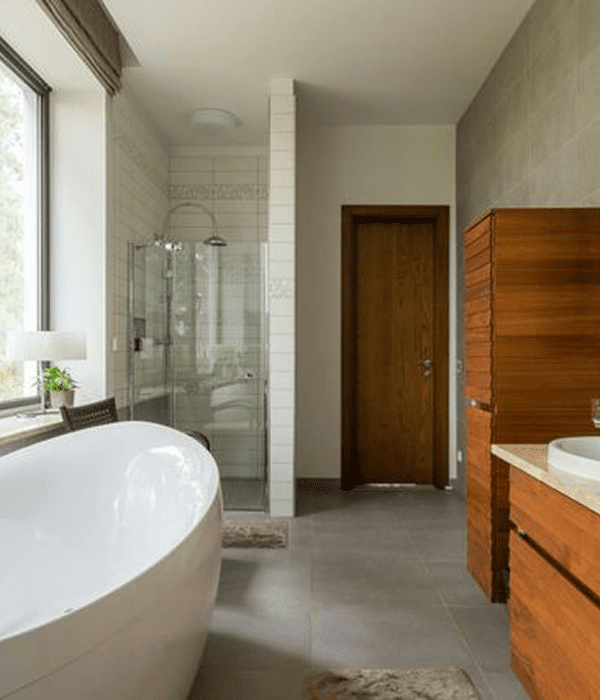 Modern bathroom with bathtub and shower area.