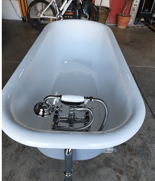White freestanding bathtub with chrome faucet.